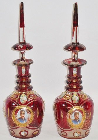 *PAIR OF RUBY GLASS DECANTERS: Having enamel floral design and transfer print portrait plaques on front and back, approximate height 20 1/2".