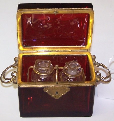 *RUBY GLASS CASKET: Having gilt metal mountings and fitted interior opening to 2 bottles.