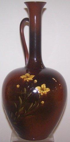 *ROOKWOOD ART POTTERY EWER: Decorated by Anna M. Valentien, having standard glaze, with yellow honeysuckle on a brown and tan ground, marks include impressed Rookwood flame logo indicating date 1891, shape #564 D, W (for white c