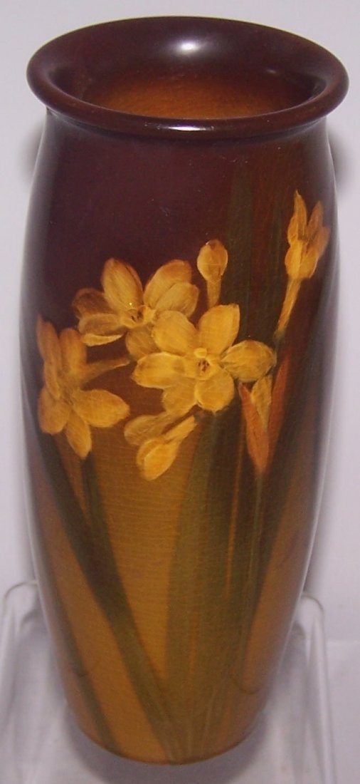 *ROOKWOOD ART POTTERY VASE: Decorated by Carrie F. Steinle, having standard glaze with yellow narcissus on a ground in shades of brown to gold, marks include impressed Rookwood flame logo indicating the date 1899, shape #808, si