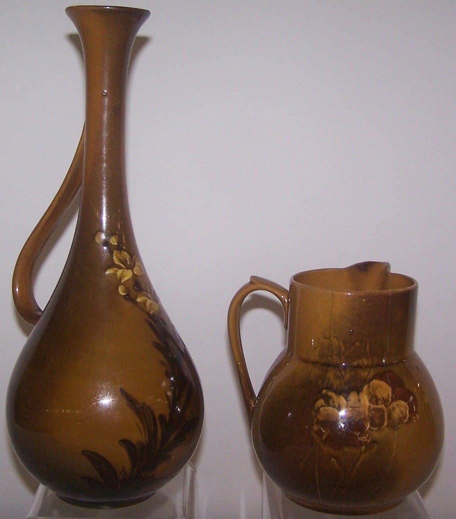 *2 PIECES OF ROOKWOOD ART POTTERY: Teapot, decorated by Anna M. Bookprinter, having early standard glaze with pansy decoration, marks include impressed Rookwood flame logo with 1 flame for date 1887, shape #88, G (for ginger or "buff" 