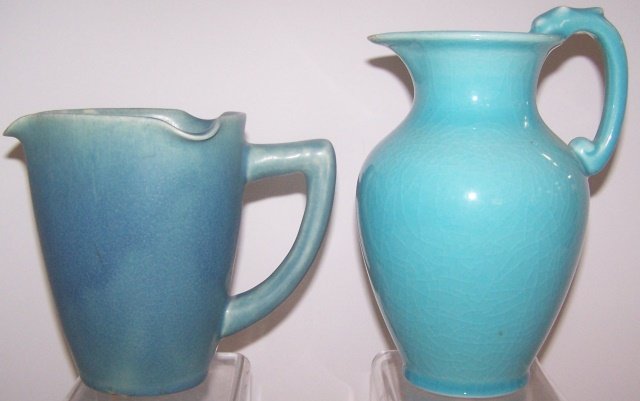 *2 ROOKWOOD ART POTTERY PITCHERS: One with blue matte glaze, marks include impressed Rookwood flame logo with Roman numeral "XI" for date 1911, shape #259 C, no apparent artist's signature, approximate height 6", and a production pitc