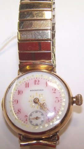 *ROCKFORD GOLD PLATED WRISTWATCH: Having white dial with red numeral markers and gilt, floral and leaf border, second subsidiary dial, works marked "Rockford Watch Co.", double roller, #852876, 15 jewel.