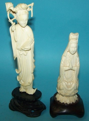 *2 CARVED IVORY SCULPTURES: Praying Buddhist on wood stand, approximate height 5", and female with lotus on wood stand, height 6". Note: Items containing ivory will only be shipped domestically and cannot be shipped to Californi