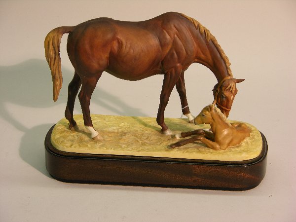 ROYAL WORCESTER PORCELAIN FIGURAL GROUP: ''The New Born'', modeled by Doris Lindner, dated 1975 and numbered 298, mounted in wood plinth.