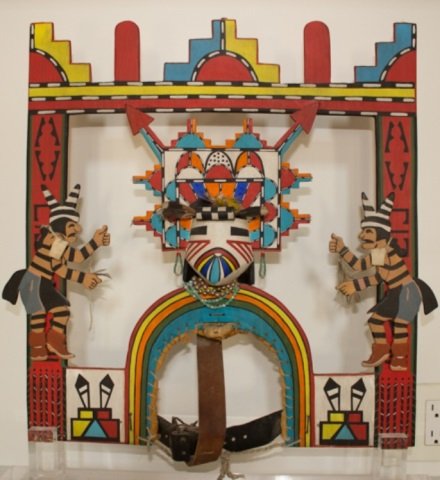 *HOPI TABLITA: Hopi Salako Kachina face with tadpoles and 2 Hano Clowns with feathers on head, beads around neck, earrings, including leather straps, 1950, approximate height 20", width 20 1/4", depth 3 3/4" (mounte