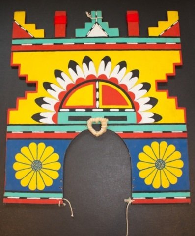 *HOPI TABLITA: Tawa Sun kachina with flowers on front and butterfly on back, including strings, approximate height 8 1/4", width 16".
