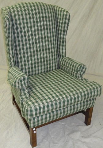 *GEORGIAN STYLE WINGBACK ARMCHAIR: Having green plaid upholstery and raised on square legs, approximate height 42".