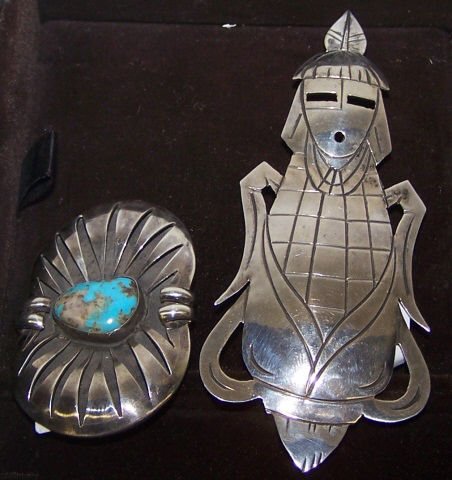 *2 NATIVE AMERICAN SILVER PINS: Carved shadowbox pin set with turquoise cabochon, approximate length 2", and large pin/pendant, Corn Maiden, stamped "AMC" and "Sterling", approximate length 4".
