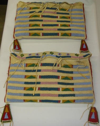*PAIR OF CROW TIPI BAGS: Hide bags with beaded decoration, in blue, green, pink and yellow, approximate length 12 1/2".