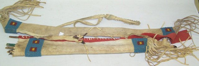 *19TH C. NATIVE AMERICAN BEADED BOW AND ARROW CASE: Hide with beaded decoration in blue, red and yellow, complete with arrows, approximate length from top of bag to end of bottom tassels 39".