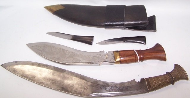 *2 NEPALESE KUKRI KNIVES: 1 with engraved blade decorated with dragons, having carved wood handle with brass mounts, approximate length 13", and 1 with plain steel blade, having embossed brass handle, length 16".