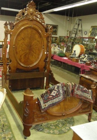 *VICTORIAN BEDSTEAD: Having heavily carved headboard decorated with leafy scroll work, approximate height of headboard 106", width 60", depth 80".