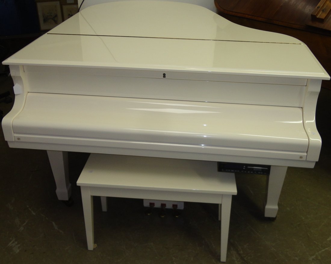 *GRAND PLAYER PIANO: With disc player, enclosed in cream colored case, raised on square tapering legs, complete with bench.