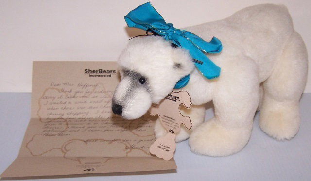 *DESIGNER BEAR: "Aurora", white polar bear by Sheridan Skinner Sher Bears, made with alpaca plush, having black glass eyes, approximate height 7", length 13".