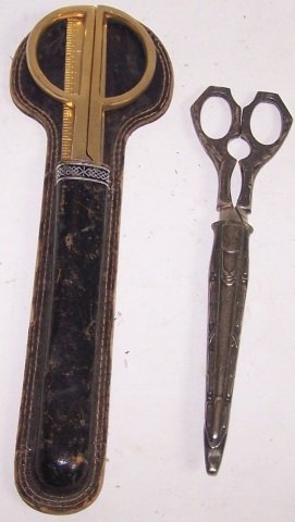*2 PAIR OF SCISSORS: 1 pair having gold tone handle with leather sheath and ruler/letter opener, marked "Stellar, Germany", other pair silvertone with silver sheath, marked "Marshall Field & Co., Germany", approximate len