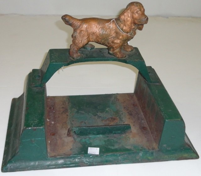 *FIGURAL IRON BOOT SCRAPE: Surmounted with dog, base having green finish.