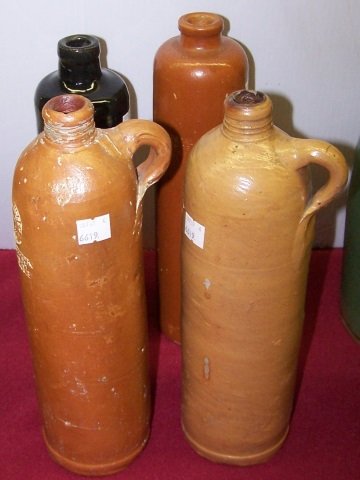 *4 STONEWARE BOTTLES: Marked illegibly, approximate height of tallest 12".