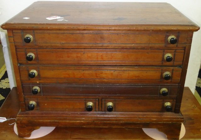 19TH C. SPOOL CABINET: Fitted with 5 drawers, raised on stand, approximate height 20 3/4", width 28 1/4", depth 18 1/4".