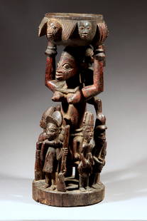 Yoruba Tray Bearer Figure "Olumeye," Nigeria: Yoruba Tray Bearer Figure "Olumeye," Nigeria This impressive sculpture of a tray bearer is surrounded by seven individuals depicting everyday activities from Yoruba life. The tray itself is surrounded