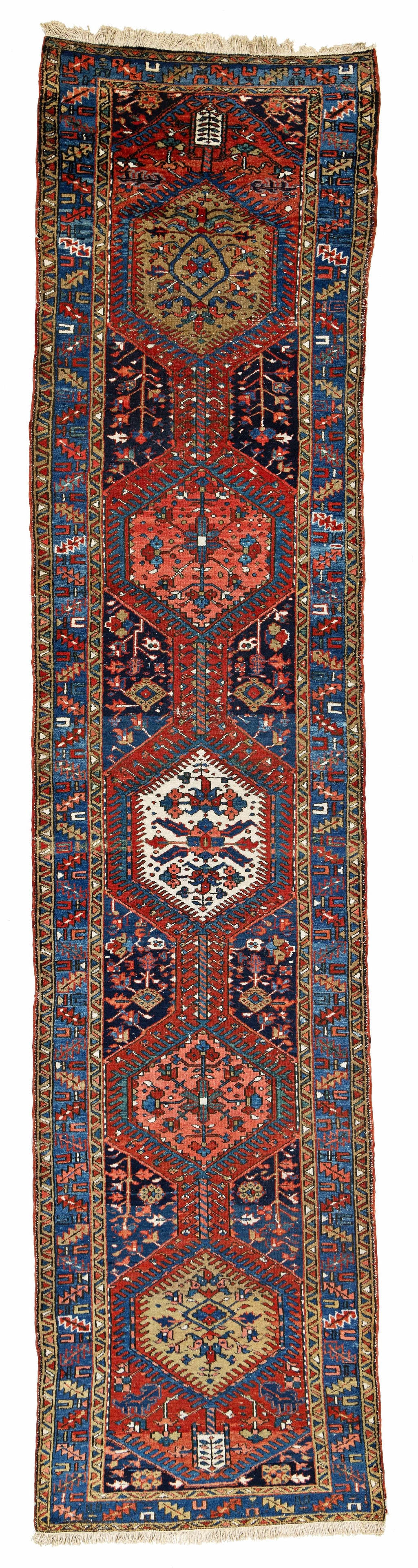 Heriz Rug: Heriz 410 x 95 cm (13' 5" x 3' 1") Persia, ca. 1930 Condition: good, low pile in places, signs of use at sides and ends, scattered small moth damages Warp: cotton, weft: cotton, pile: wool