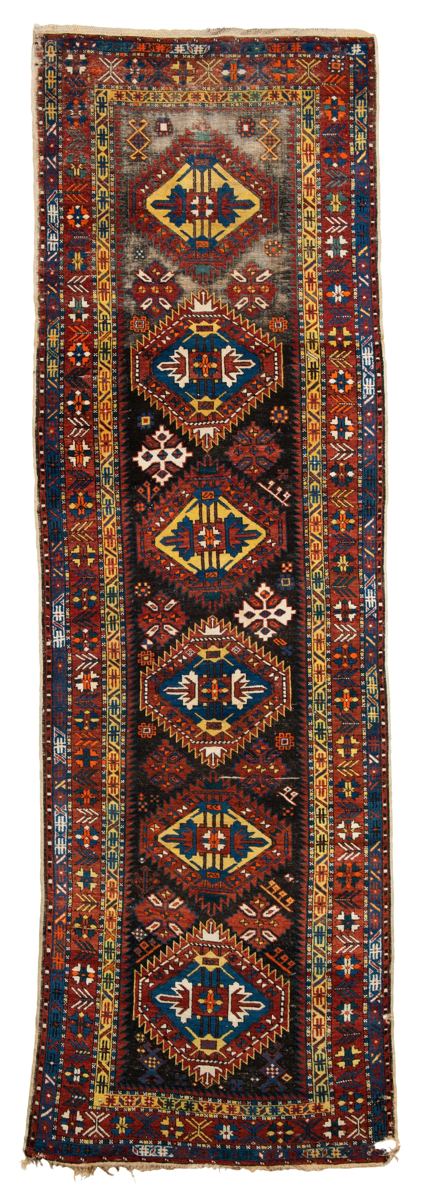 Shirvan Rug: 362 x 110 cm (11' 11" x 3' 7") Caucasus, early 20th century Condition: used, low pile in places, foundation partially visible, several missing parts and holes, signs of use Warp: cotton, weft: cotton,