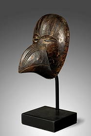 Bird Mask "Grebo": Bird Mask "Grebo" Liberia, 20.5 cm (8") This mask captivates with its finely crafted details. Seven carved lines, some indicated by short strokes, connect with the eyebrows and adorn the forehead. The