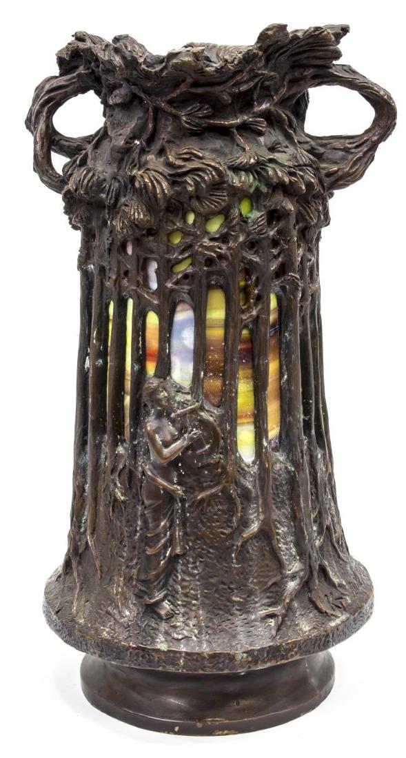 ART NOUVEAU STYLE STAINED GLASS BRONZE LAMP, KT: Art Nouveau style bronze lamp, having an open top with twisted handles, with a forest form body, set with stained glass panels to interior, single light socket, rising on circular foot, signed KT [ill