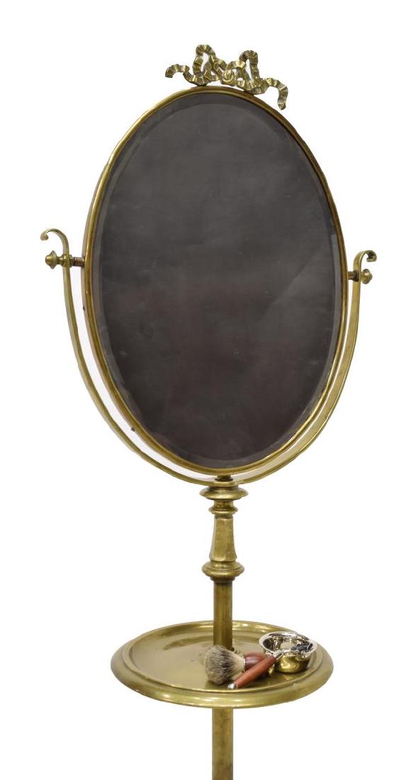(4) LOUIS XVI STYLE MIRRORED GILT SHAVING STAND: (lot of 4) Louis XVI style gentleman's mirrored shaving floor stand, executed in brass, a stylized bow over beveled oval mirror, above medial shelf, rising on three legs, accompanied by shaving kit, i