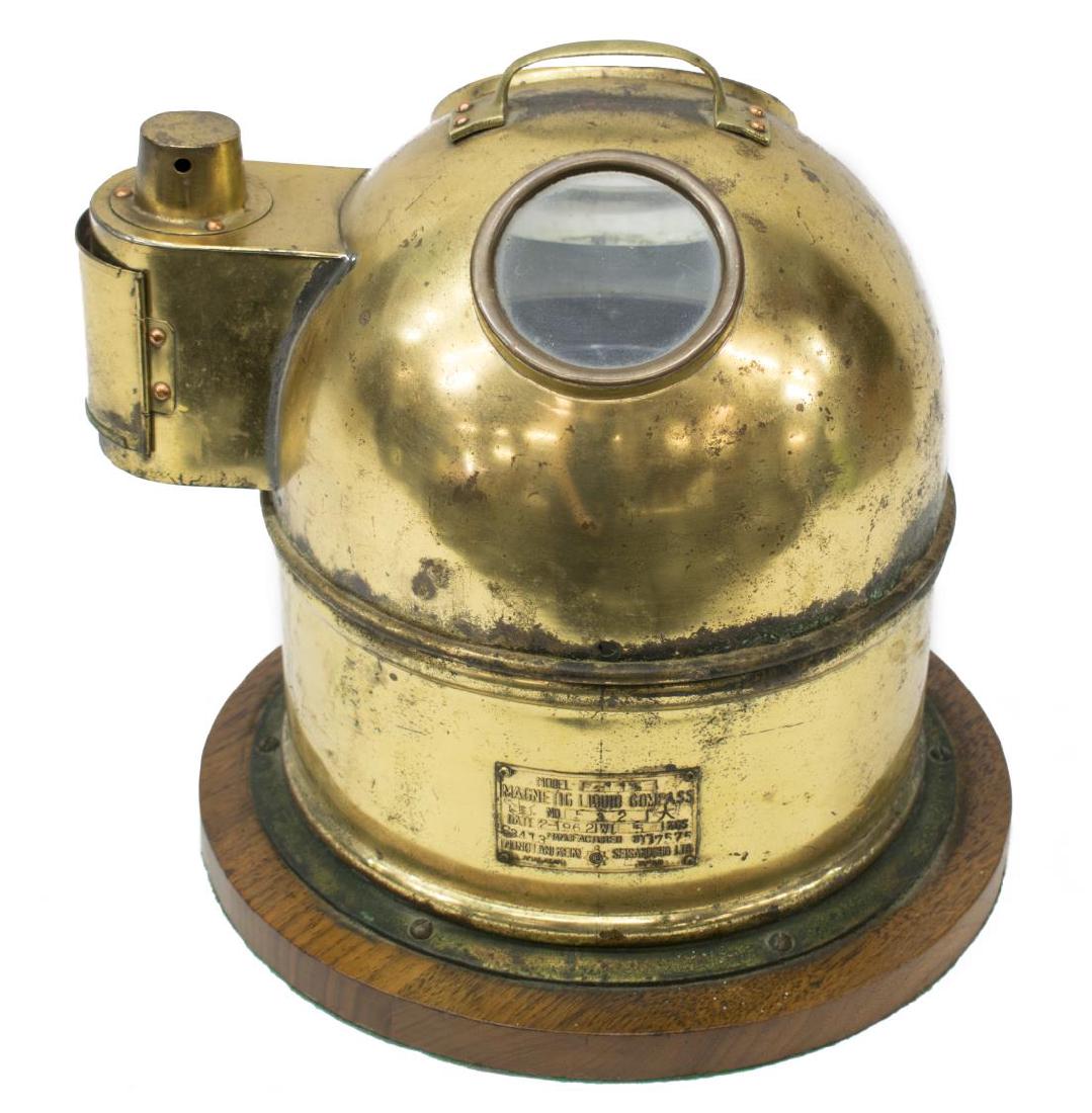 JAPANESE MAGNETIC SHIPS COMPASS: Magnetic ships compass by Nunotani Keiki Seisakusho Co Ltd. Japan, Model P115, brass binnacle case with corrosion, two glass ports, kerosene oil lamp enclosed at one side, mounted on a wood base, 11.5