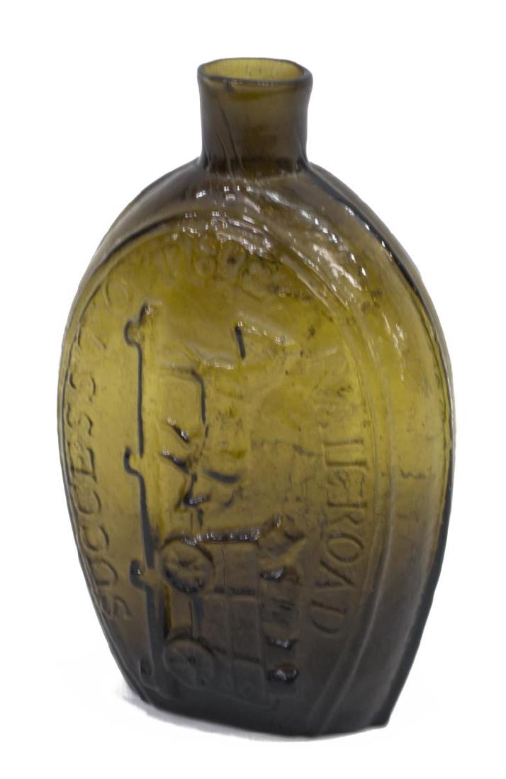 GLASS FLASK, "SUCCESS TO THE RAILROAD": Glass flask, "Success to the Railroad" in raised lettering with a depiction on two sides of a horse drawer wagon, approx. 7"h, 4.5"w, 2.5"d, .75lbs Start Price: $80.00