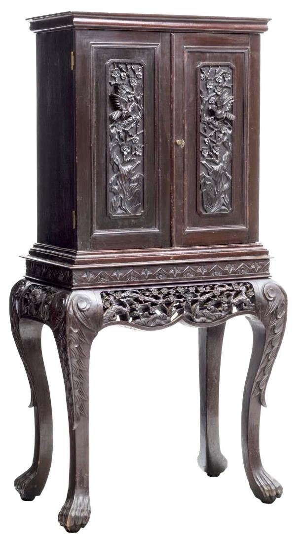 CHINESE RELIEF CARVED & FITTED SILVER CHEST: Chinese carved hardwood silver chest, an overhang cornice above two locking doors, carved in relief with songbirds and flowering branches, interior fitted with eight lined drawers, floral carved open 
