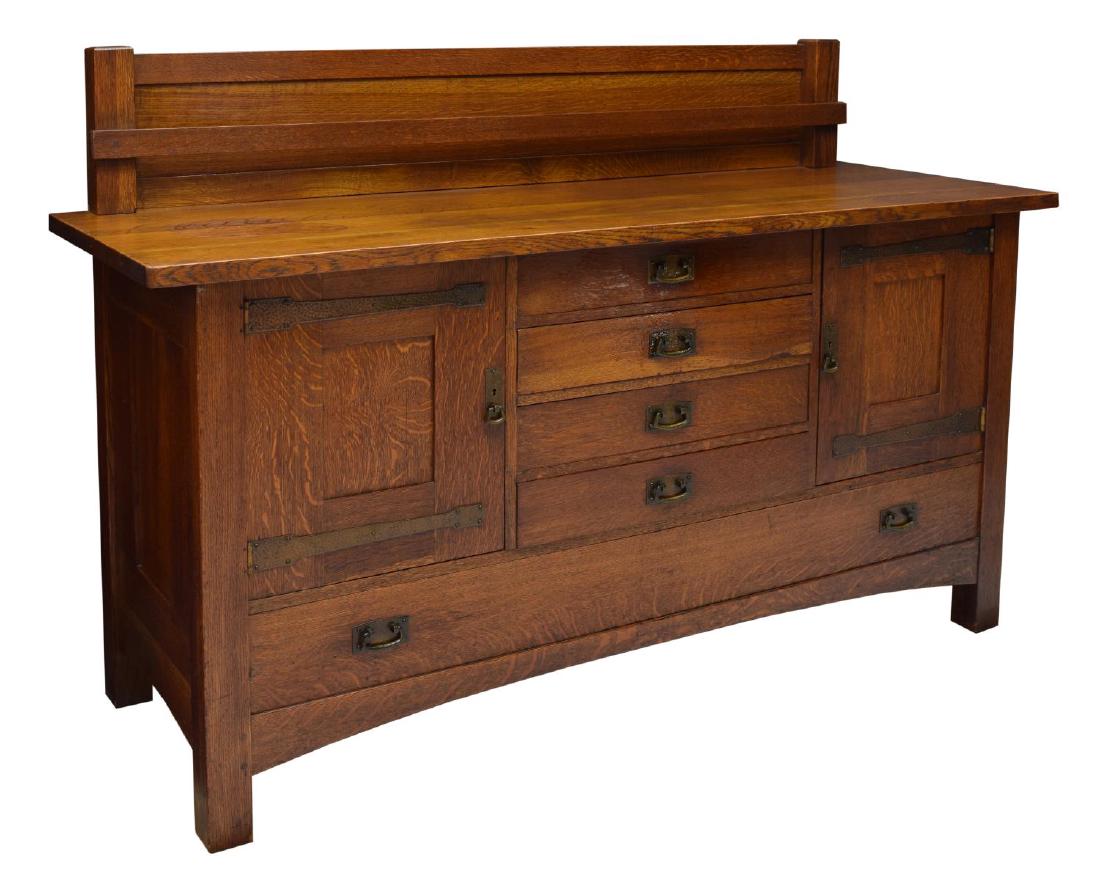 L & JG STICKLEY SIGNED OAK SIDEBOARD: L & JG Stickley oak sideboard, the rectangular top with a plate display back rail over four central drawers flanked at each side by a door with strap hinges, all over a lower long drawer, rising on sq