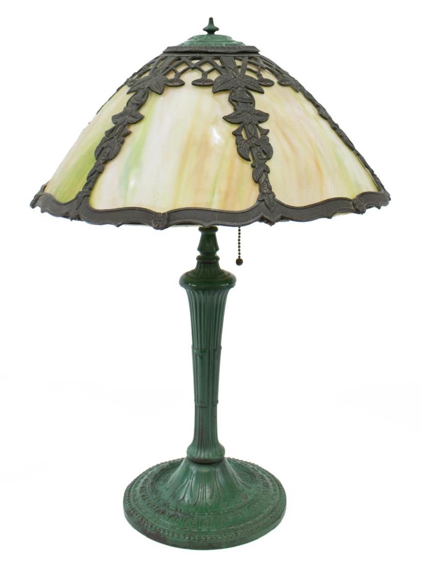 ARTS & CRAFTS SLAG GLASS TWO-LIGHT TABLE LAMP: Arts and Crafts style slag glass table lamp, the glass paneled shade accented by ivy trim, over the central standard issuing two lights, rising on circular foot, standard has been painted green, 14.25