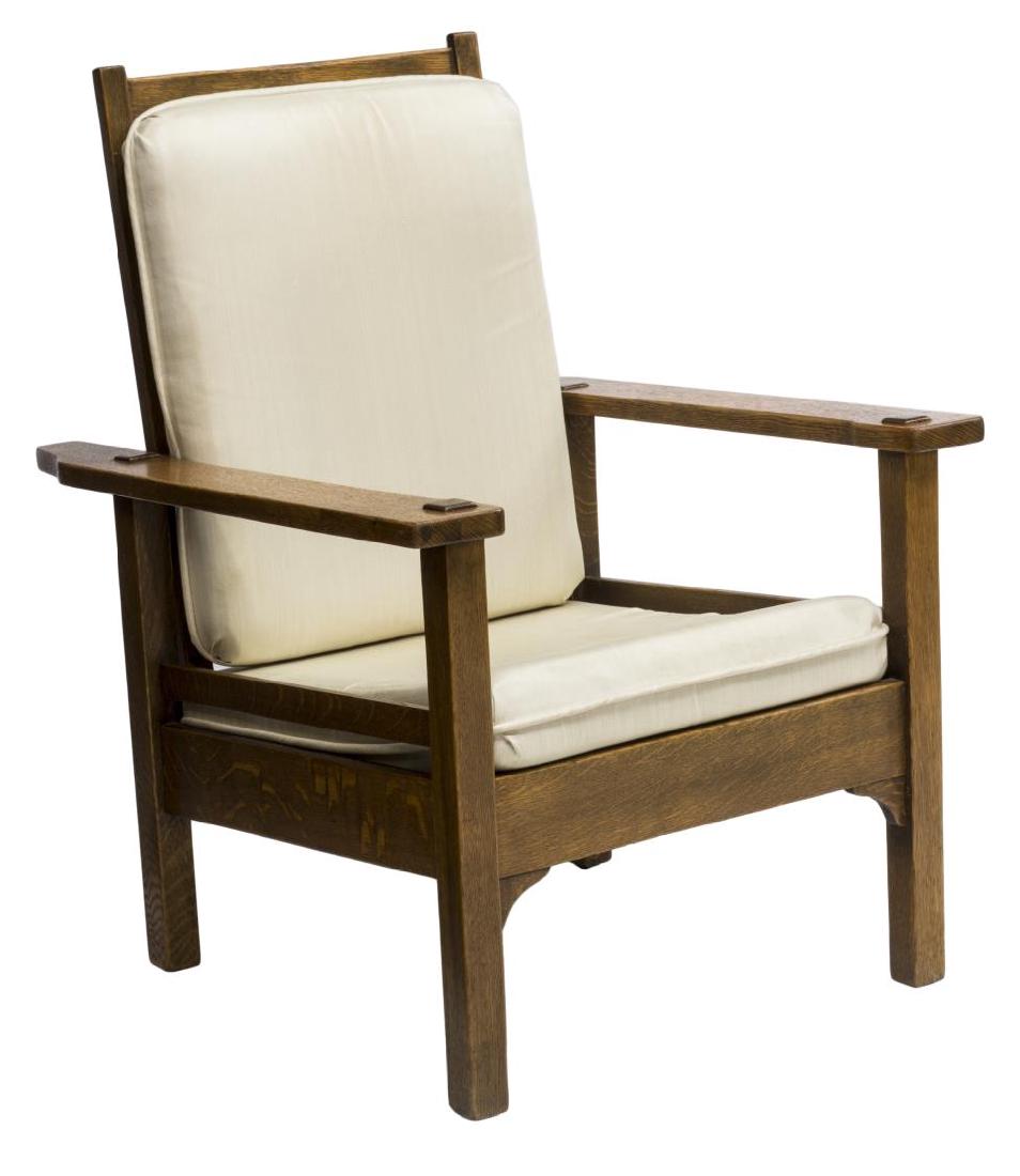 ARTS & CRAFTS STYLE OAK MORRIS CHAIR: Arts & Crafts style oak Morris chair having a reclining back held by turned pegs, removable beige fabric back and seat cushions, rising on straight legs,40"h, 28.5"w, 33.75"d Start Price: $200.00