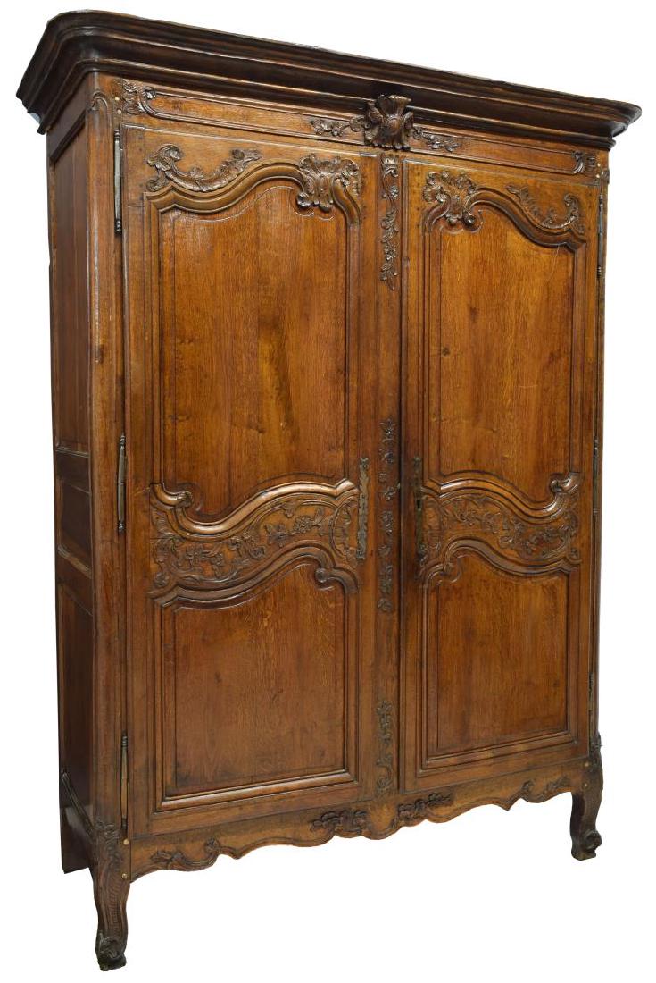 FRENCH LOUIS XV 18TH C. ARMOIRE: French Louis XV armoire, 18th c., a protruding cornice over two foliate carved doors, rising on scroll foot cabriole supports, approx. 82.5"h, 56.5"w, 23"d Start Price: $400.00