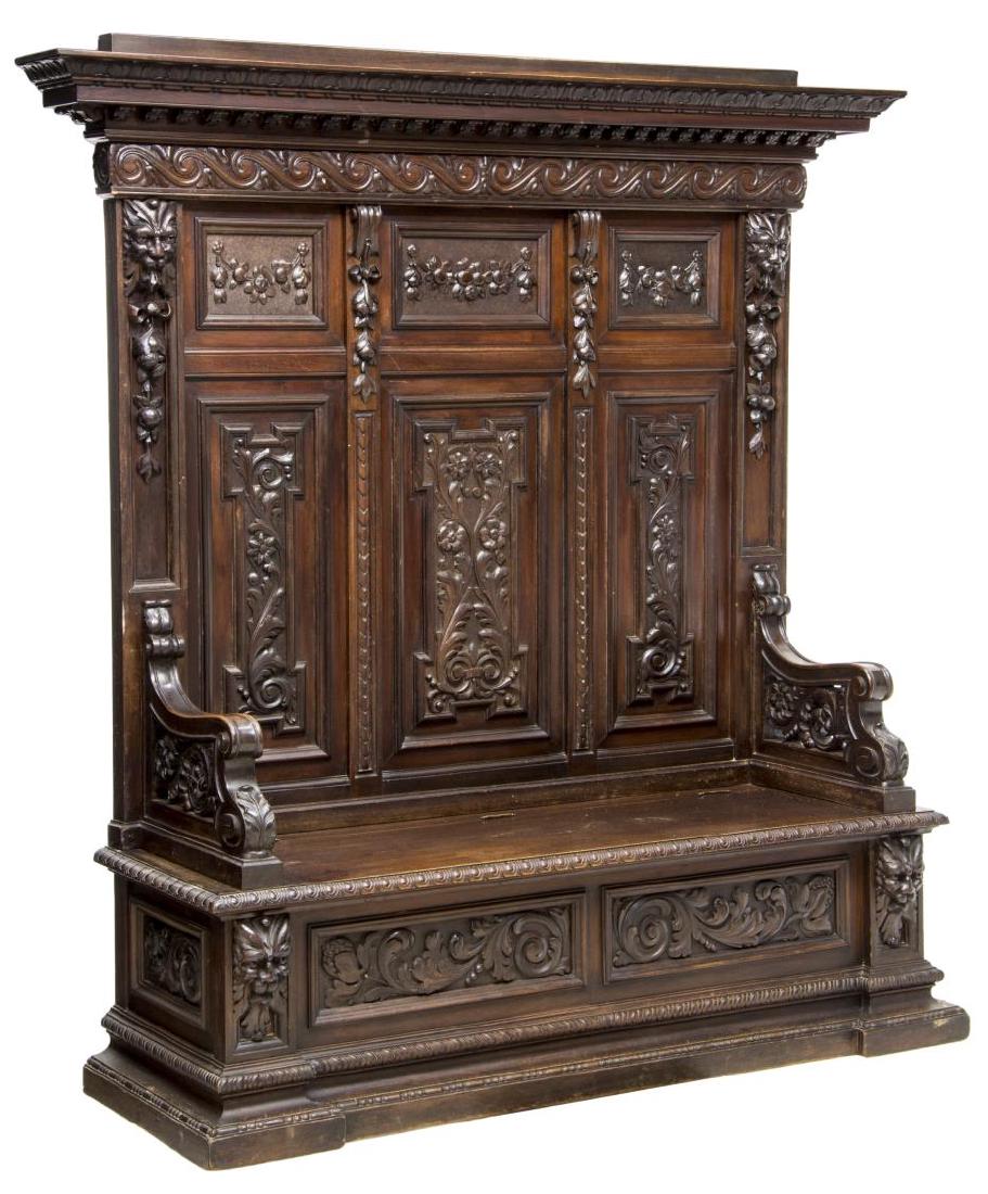 LARGE ITALIAN RENAISSANCE REVIVAL HALL BENCH: Large Italian Renaissance Revival carved wood hall bench, 19th c., a protruding cornice over Greek wave frieze, figural animal heads to each side, above the paneled back with fruit and floral carving,