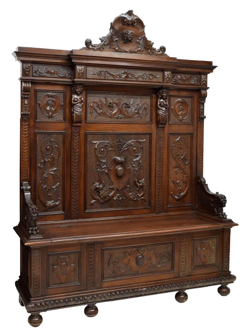 ITALIAN RENAISSANCE REVIVAL CARVED HALL BENCH: Italian Renaissance Revival carved hall bench, 19th c.. having a corniced top over foliate frieze, segmented with figural pilasters, griffins, foliates, and dolphin accented panels, above curved armre