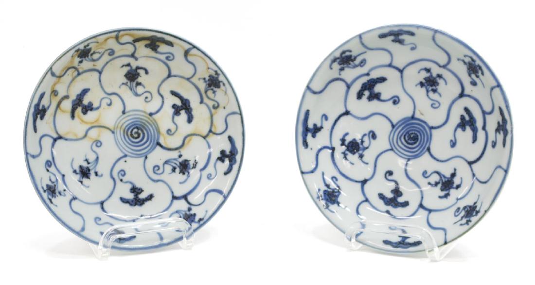 (2) CHINESE MING ERA BLUE & WHITE PLATES 7" DIAM.: (pair) Chinese blue and white small plates, Ming Dynasty, each with "heap and pile" floral pattern centered by swirl, one with staining, both signed underfoot, 1.25"h, 7" diam., 2lbs **Provenance: Fro