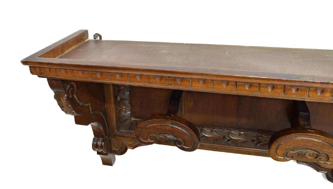 RENAISSANCE REVIVAL CARVED HANGING HAT RACK: Renaissance Revival hanging hat rack, running ornamentation over four shaped and carved hooks, on foliate trimmed back panel, approx 14.25"h, 47.75"l, 8.5"d Start Price: $100.00