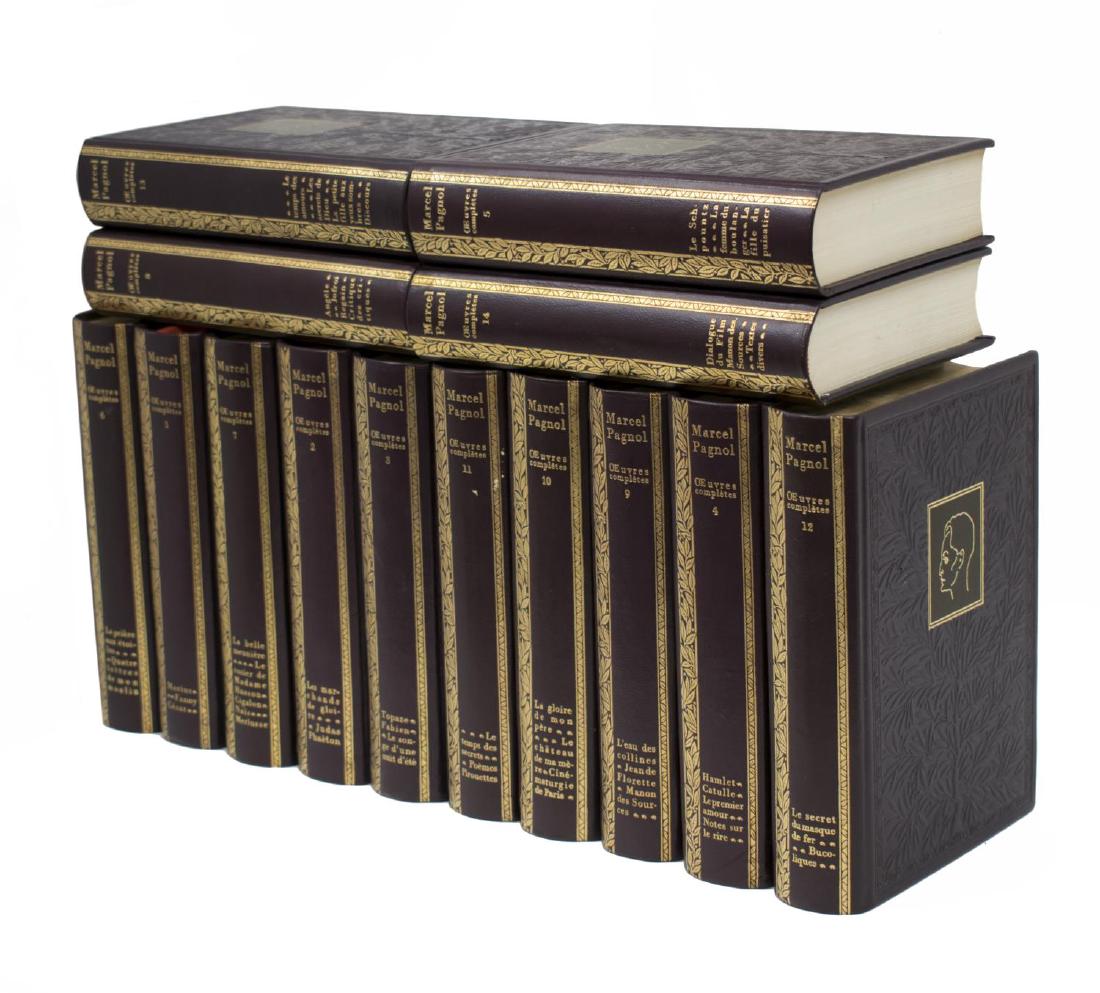 (14) FRENCH LEATHER BOUND LIBRARY BOOKS SET: (lot of 14) French purple embossed leather bound library books set, The Complete Works by Marcel Pagnol, gilt lettering to spine, each: approx 8.5"h, 1.75"w, 6"d, 27lbs total Start Price: $80.00