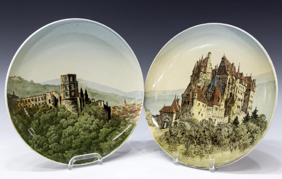 (2) METTLACH CASTLE VIEW PLAQUES, #1044 / 95 & 130: (lot of 2) Villeroy & Bach Mettlach scenic castle view chargers, including: Burg Eltz, #1044 / 95, painted V & B over M mark along with other marks as pictured verso, overall crazing, gilt loss and sm