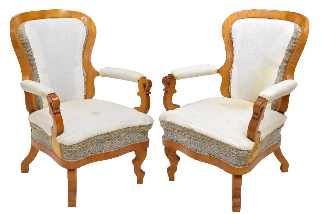 (2) BIEDERMEIER STYLE CHERRYWOOD ARMCHAIRS: (pair) Biedermeier style cherrywood armchairs, the curved wood frame back with cushion over seat, open scrolled and padded arms, rising on wide cabriole legs, in need of upholstery, (one) with restora