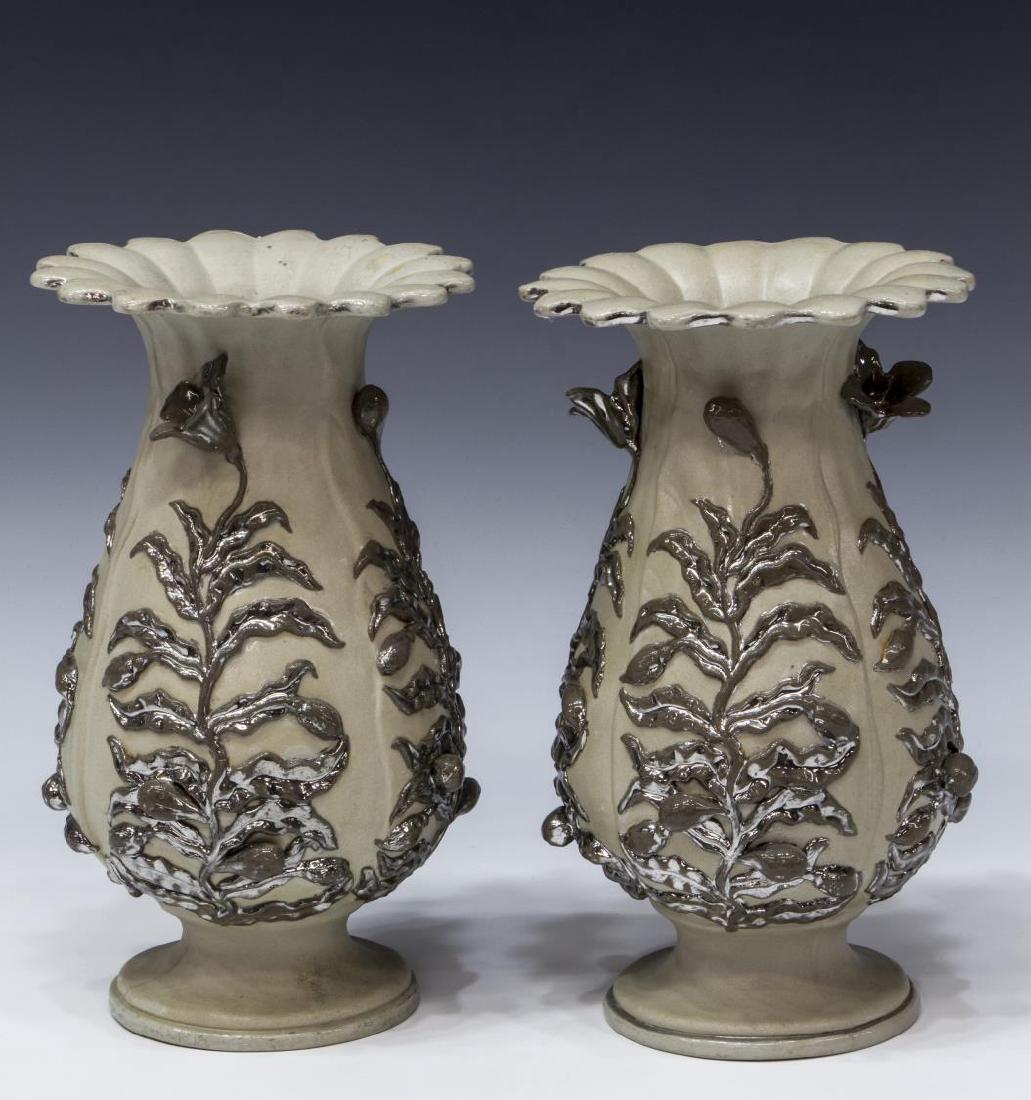 (2) ANTIQUE METTLACH SILVER LUSTER STONEWARE VASES: (pair) Mettlach stoneware lustre vases, applied eagle and medallion mark, c. 1844-1860's, each having fluted flared rim, over baluster form body applied with silver lustre budding flower vines, on a c