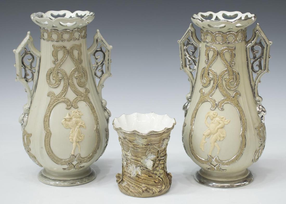 (3) ANTIQUE METTLACH SILVER LUSTER STONEWARE VASES: (lot of 3) Mettlach silver lustre stoneware vases: (1) having scalloped pierced rims and Gothic inspired handles, baluster body reserved with figures in relief, both on pedestal foot, applied mark imp