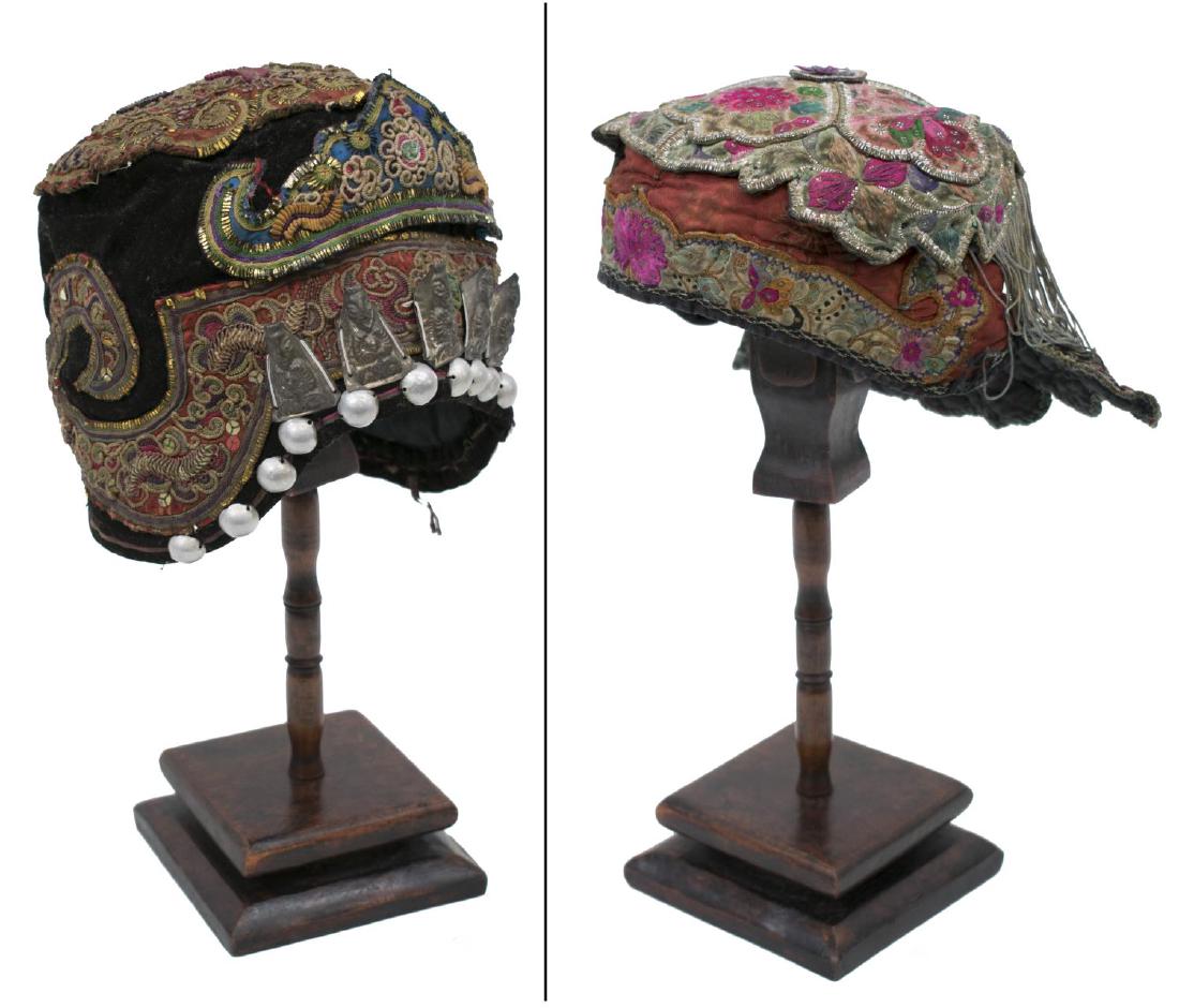 (2) ANTIQUE MONOGOLIAN EMBROIDERED CHILDREN'S HATS: (lot of 2) Antique Mongolian children's hats, both embroidered with flowers, heavy gilt thread: (1) having metal domed cabochons beneath applied metal deity accents, felt ground with bells verso, on a