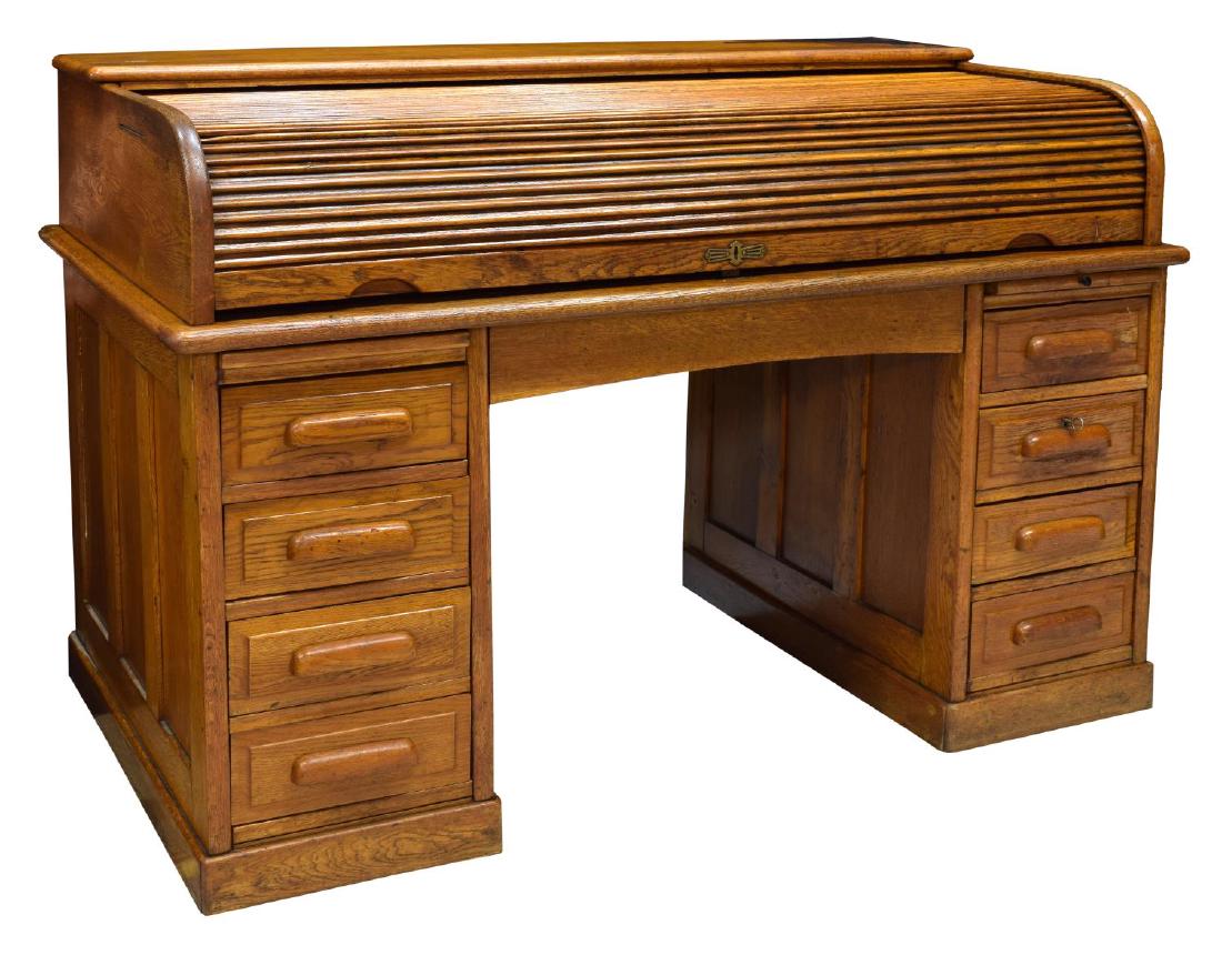 CONTINENTAL ROLL TOP OAK WRITING DESK: Continental roll top oak writing desk, rectangular shelf above roll top, opening to the fitted gallery with slots and drawers set over the four drawer double pedestal supports, 41"h, 58"w, 32.75"d Sta