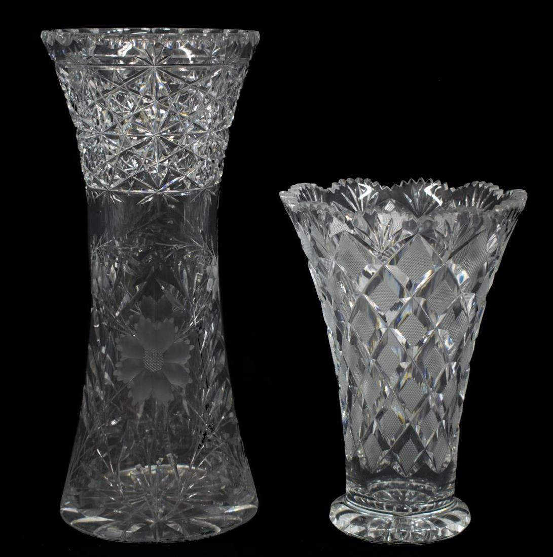 (2) AMERICAN CUT GLASS CORSET & TRUMPET VASES: (lot of 2) American cut glass vases, comprising: (1) crosshatched trumpet vase, with a scalloped saw tooth rim over tapered body, 8"h, 5.75" diam.; (1) corset vase, having a scalloped indented rim ove
