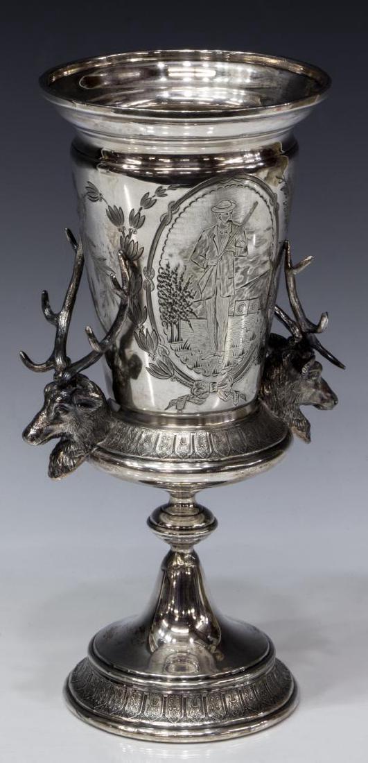 REED & BARTON ENGRAVED HUNTER STAG TROPHY CUP: Reed and Barton silver plate stag handled trophy cup, engraved with trailing overall with trailing vines, one side showing hunter with gun, the other monogrammed, all on a pedestal foot, approx 10.75"
