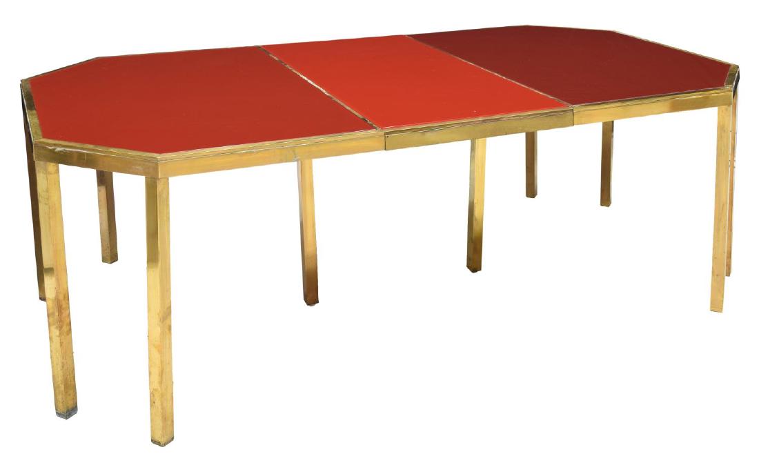 GUY LEFEVRE FOR MAISON JANSEN BRASS & GLASS TABLE: Brass and red glass dining table with leaf, c.1970, France, designed by Guy Lefevre for Maison Jansen, having removable red glass top, rising on square brass legs, approx. 28.25"h, 77.5"w, 43"d Start